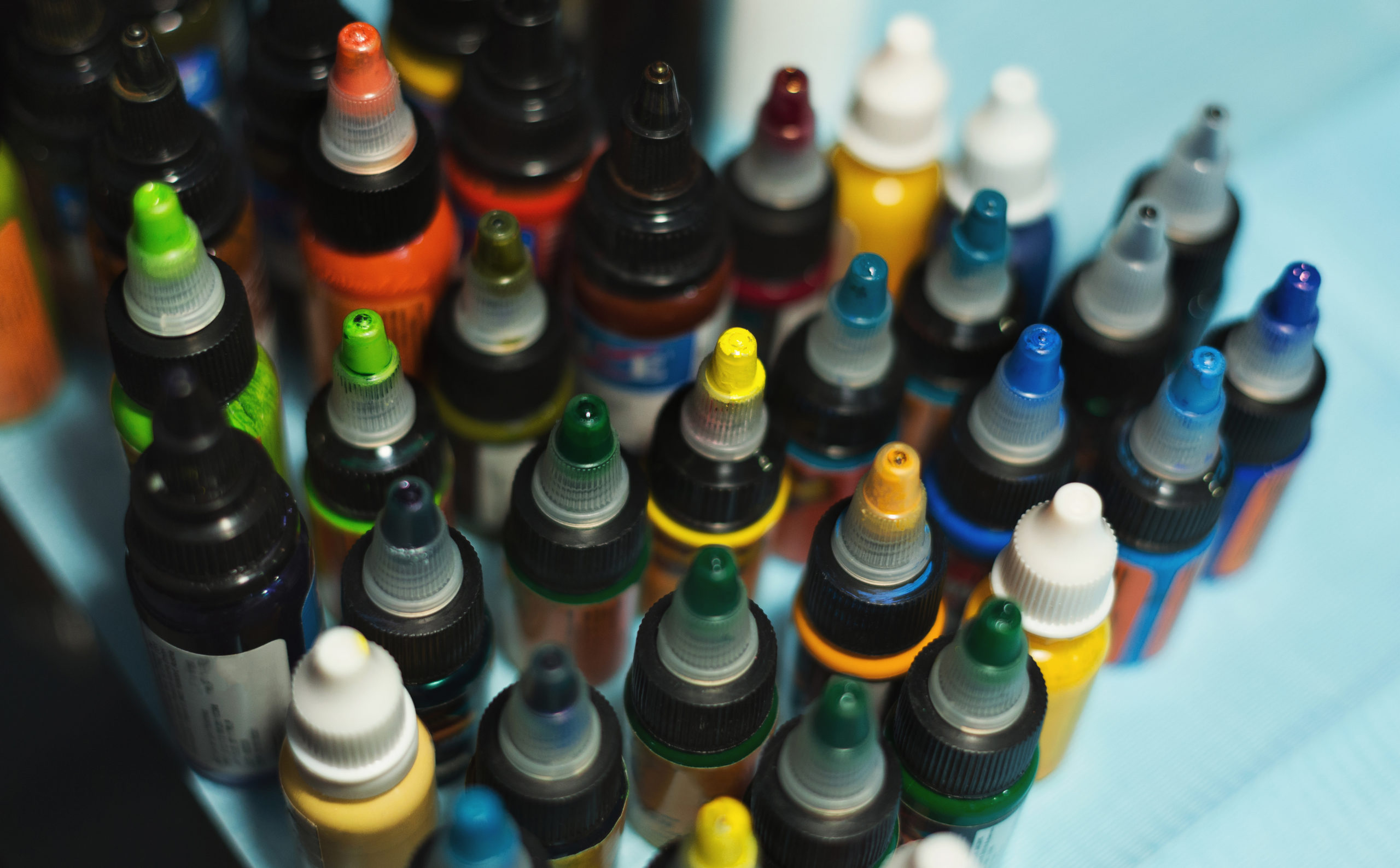 Multiple bottles with colorful inks for tattoo